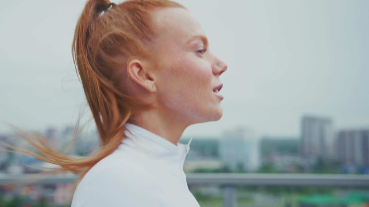 Redhead woman running in the city