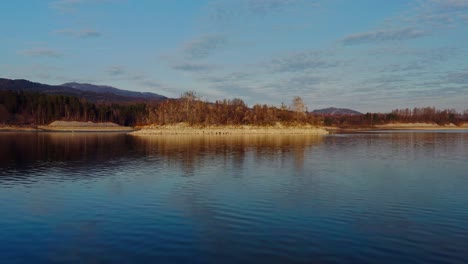 Still-Water-With-Reflections-Of-Flying-Birds-On-A-Pond