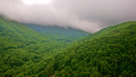 smoky mountain wilderness obscured by mist, drone perspective