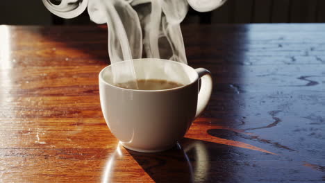 a cup of hot coffee on a wooden table