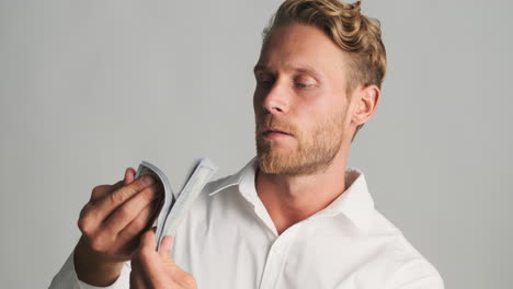 blond businessman holding money banknotes