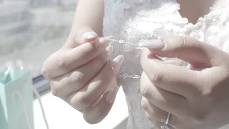 a bride wearing a weeding white dress with the wedding necklace