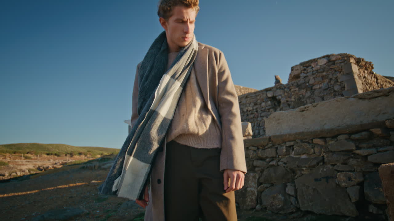 Thinking man touching scarf resting windy nature closeup. Guy walking nature