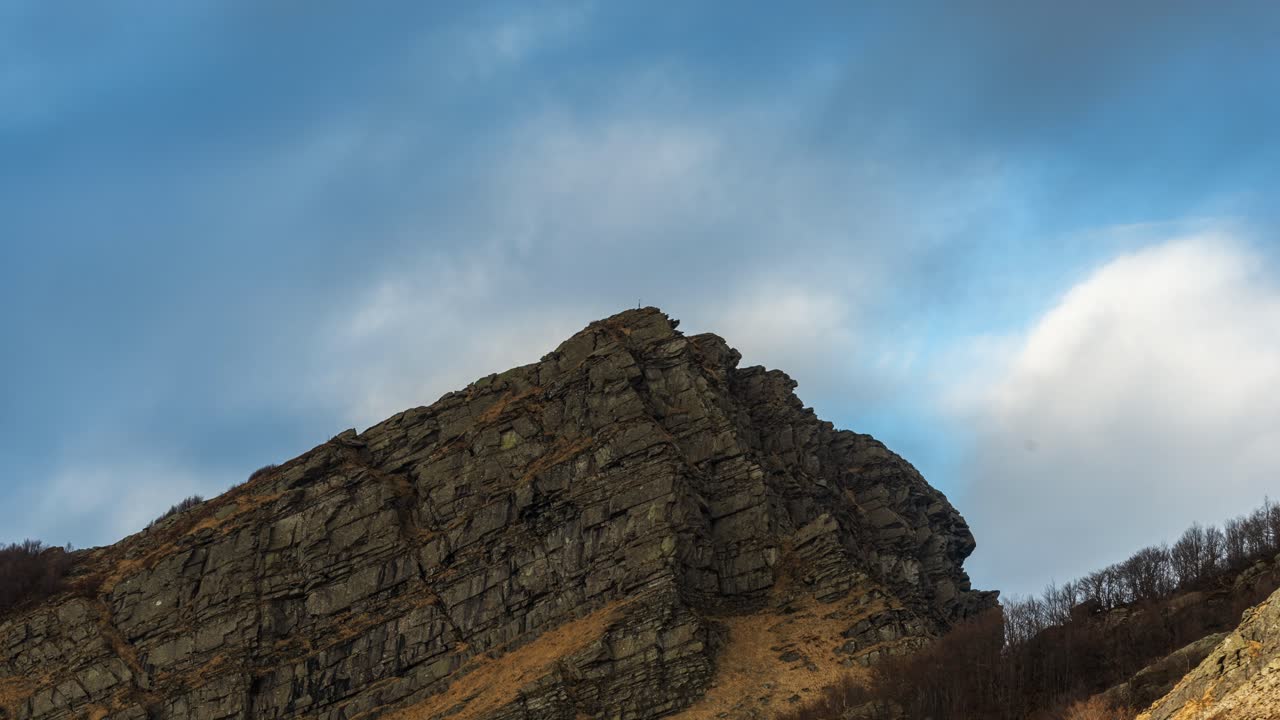 Mountain peak with rocky formation, time-lapse sky changing over Dolomites