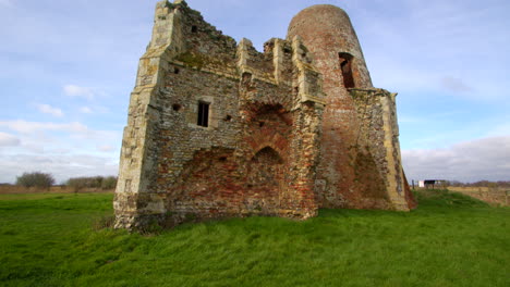 Tilting-Wide-shot-of-St-Benet’s-abbey-16th-century-gatehouse-with-18th-century-windmill