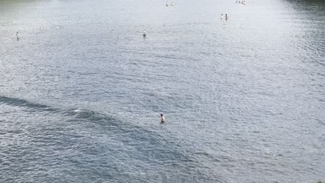 beautiful coastal town with people swimming in calm ocean waters