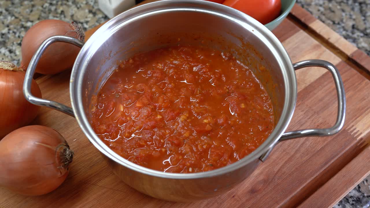 A Classic Fileto Tomato Sauce Simmers With Fresh Onions and Ripe Tomatoes - High Angle Shot