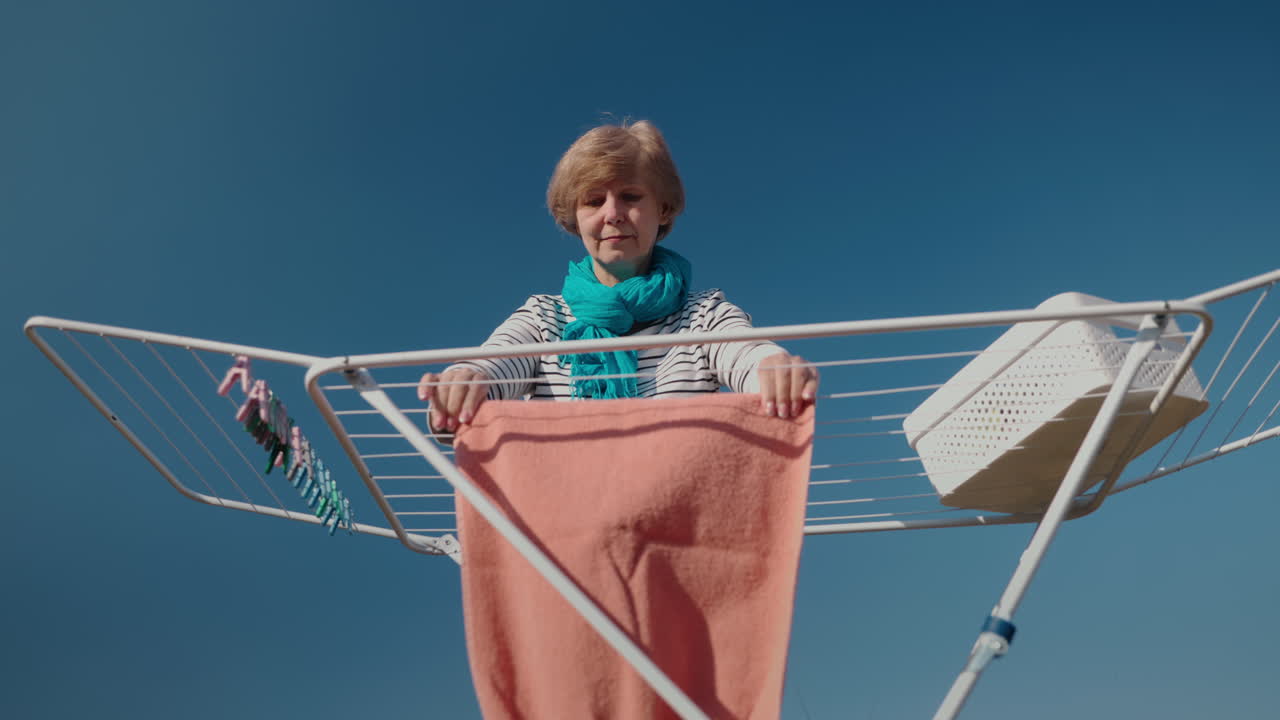 Woman Drying Clothes Outdoors