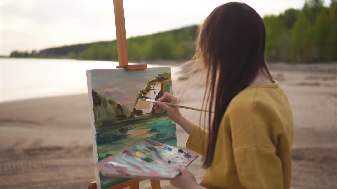 Woman Painting Landscape on Beach at Sunset