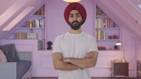 confident sikh indian man standing crossed hands