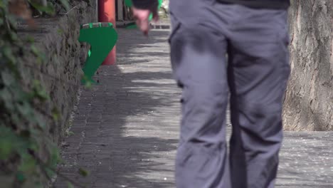 person walking down a brick sidewalk