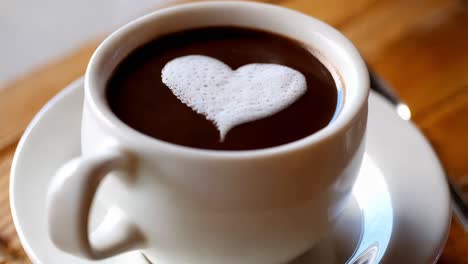 heart shaped foam in a cup of coffee