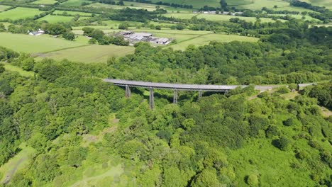 aerial view of meldon viaduct, a disused railway bridge crossing west okement river, now a pedestrian pathway