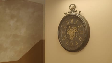 decorative wall clock with roman numerals and exposed gears