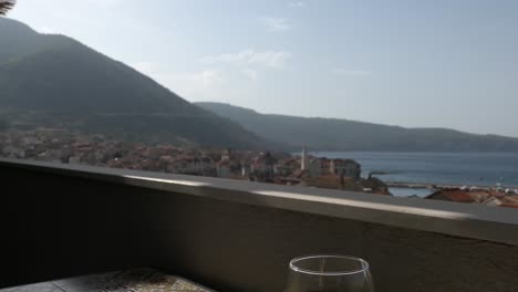Old-town,-sea,-mountains-and-wine-glass-on-balcony,-Komiza,-Vis,-Croatia