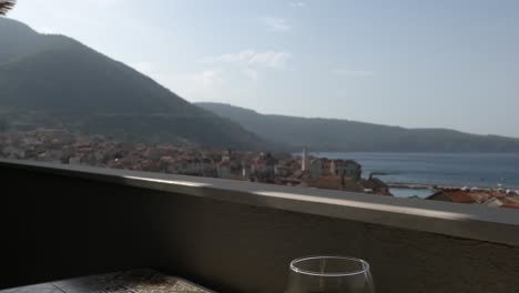 old town, sea, mountains and wine glass on balcony, komiza, vis, croatia