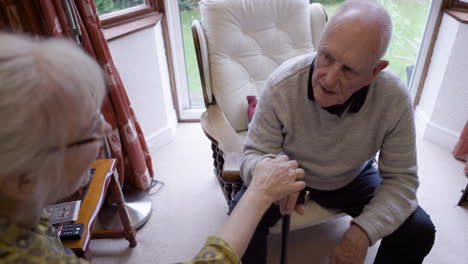 elderly couple sharing a tender moment at home
