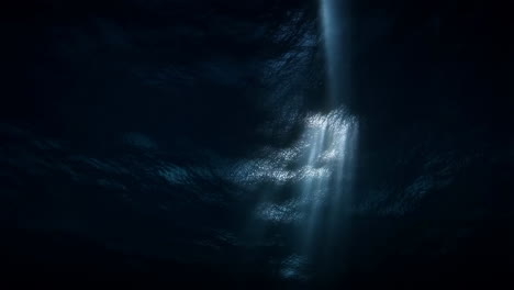 light rays penetrating dark water from below