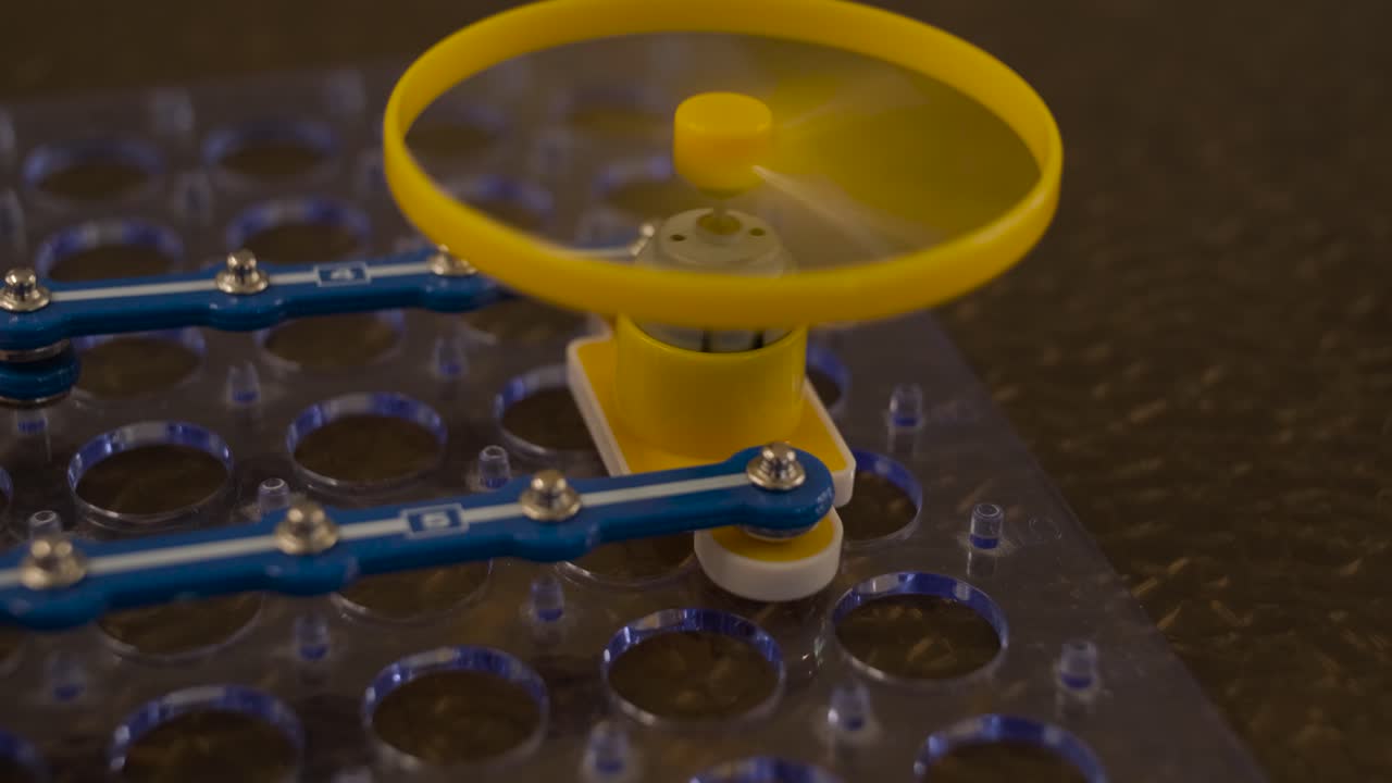 Small Yellow Fan Spinning on an Electronic Circuit Board