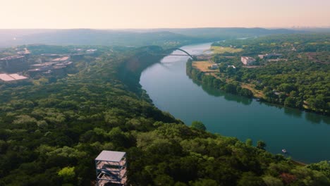 flying over greenbelt in austin, texas near 360 pennybacker bridge during hazy summer sunrise, 4k lake drone footage 2022