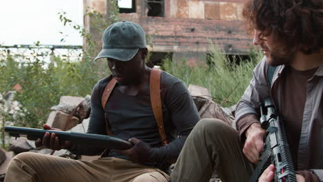 men guarding an abandoned building