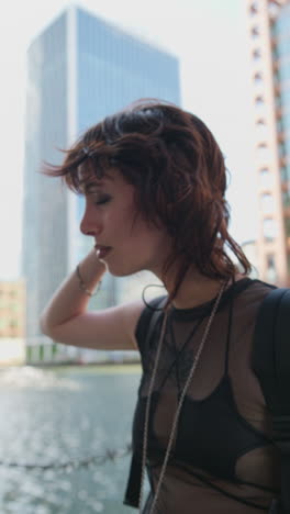 Vertical-Video-Outdoor-Fashion-Portrait-Of-Young-Alternative-Style-Woman-With-Tattoos-And-Piercing-At-Canary-Wharf-In-London-Docklands-Shot-In-Real-Time-2