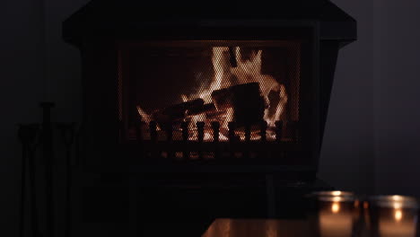 steady shot of a living room with a burning fireplace