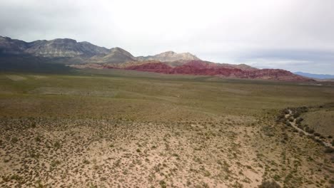 Aerial-push-forward-with-red-rocks-of-Red-Rock-Canyon-in-the-background-in-4K