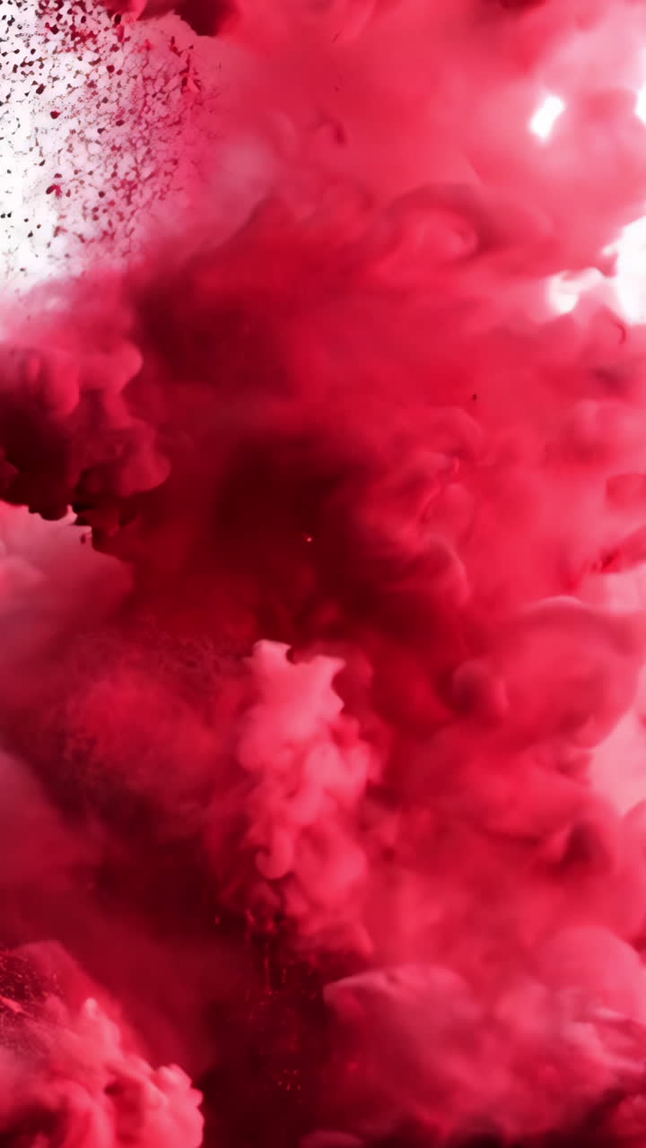 A red cloud of smoke is billowing out of a fire. The smoke is thick and dense, creating a sense of chaos and destruction. The red color of the smoke adds to the intensity of the scene