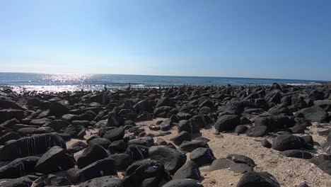 Black-volcanic-rock-makes-up-part-of-the-shoreline-of-Rocky-Point,-Puerto-Peñasco,-Gulf-of-California,-Pacific-Ocean,-Mexico