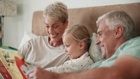bed, grandparents and girl reading book