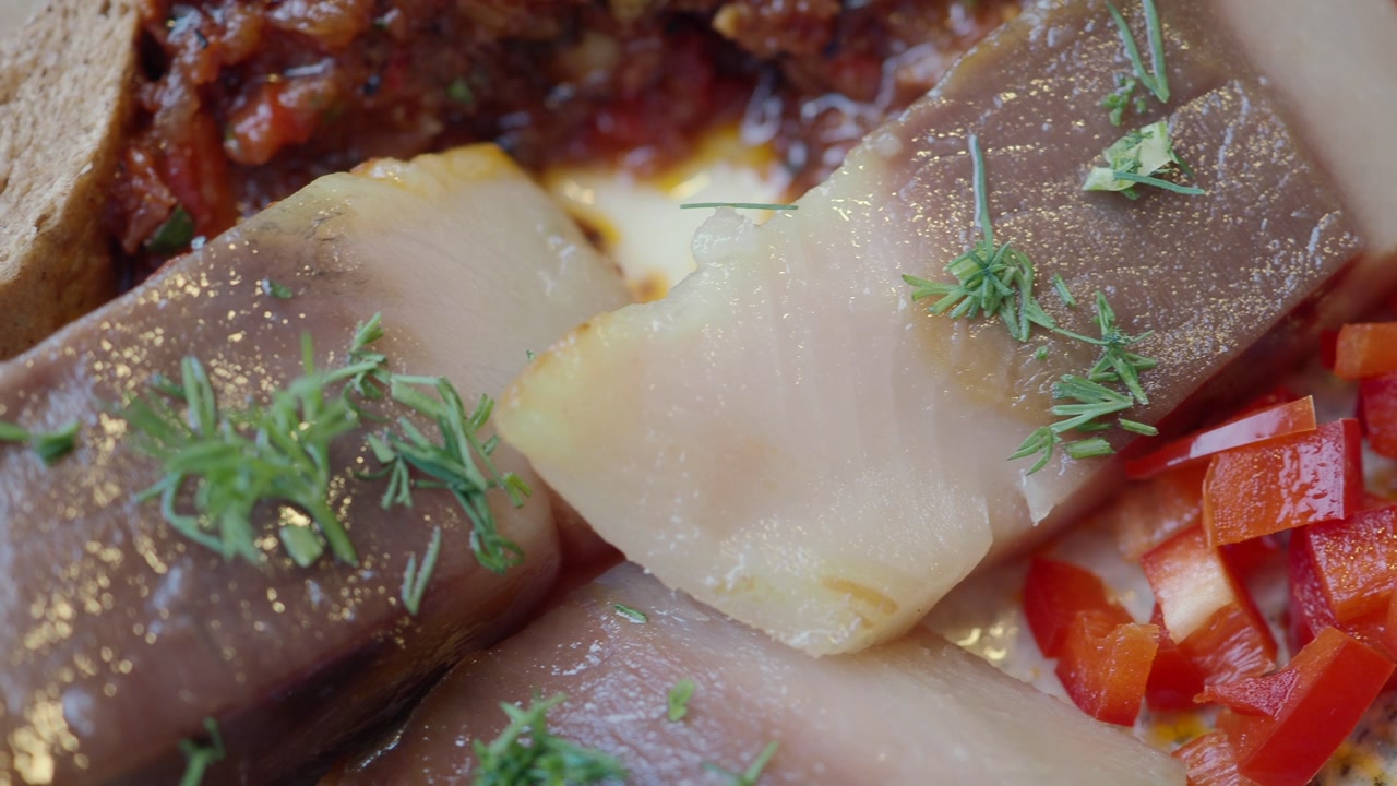 Marinated Herring Slices Garnished with Fresh Dill and Bell Pepper