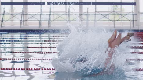 swimmers diving into the pool