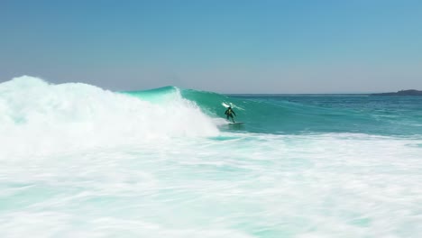 surfer rides big ocean barrel wave at jervis bay, australia. water sport aerial shot
