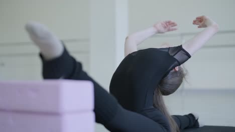 young ballet girl at studio lesson. training performance. stretching exercise pose. ballerina practice balance technique. classical elegance fitness.