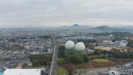 train zooming by with mountains in the background on a cloudy autumn morning in kusatsu, shiga prefecture, japan