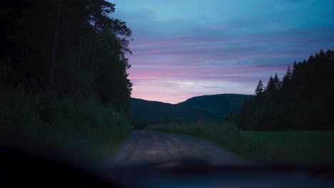 scenic sunset nature viewed from the front glass window inside a vehicle