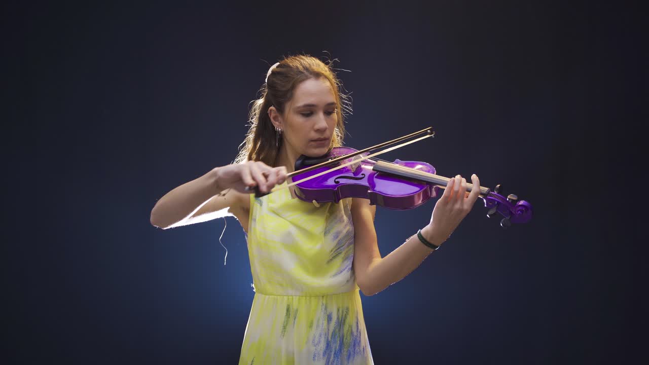 joven y hermosa mujer músico tocando el violín.