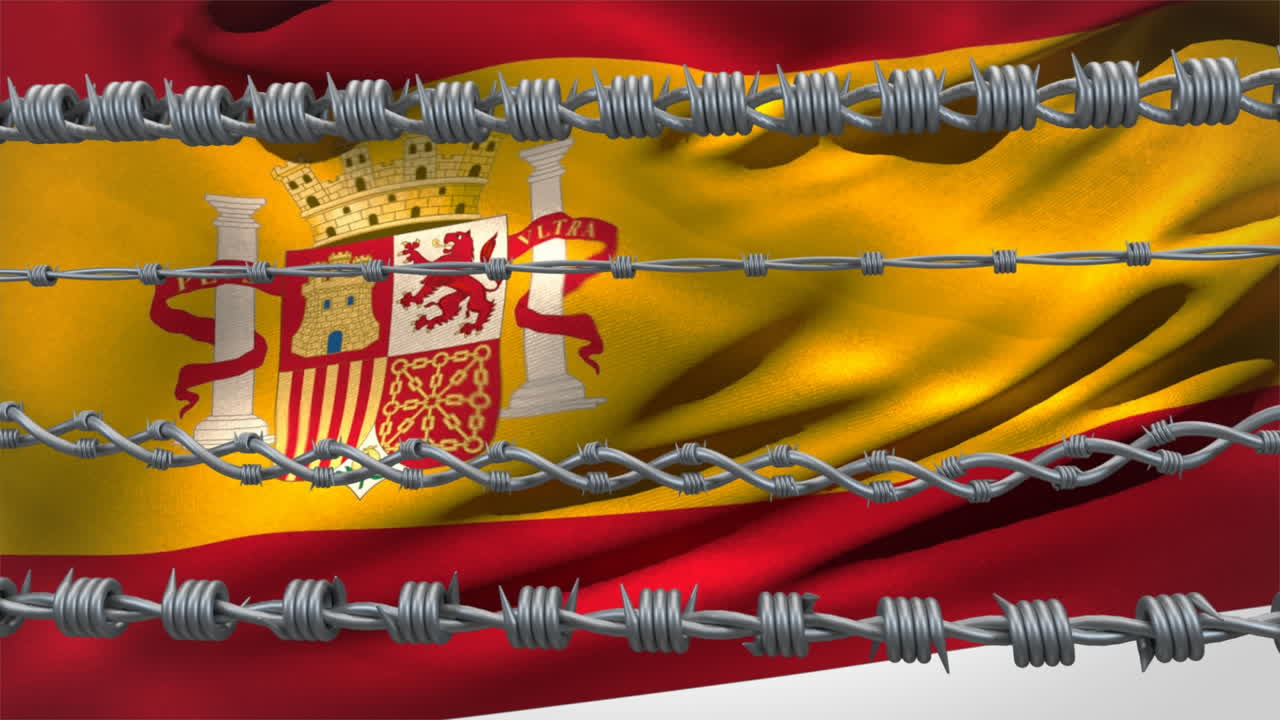 Fili spinati contro la bandiera della Spagna