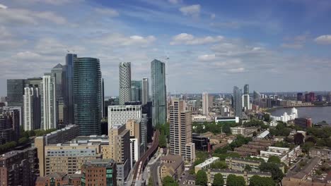 aerial drone panning from canary wharf to the river thames in london in a beautiful sunny day