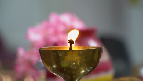 lit brass lamp or diya used in hindu temple burning during fire ritual of havan