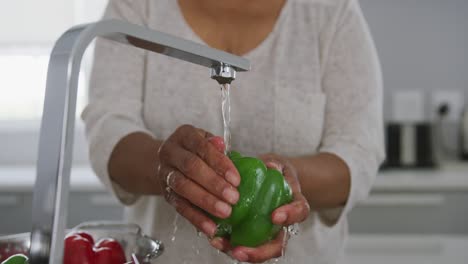 A-senior-African-american-woman-spending-time-at-home-and-cooking.-Social-distancing-in-quarantine.