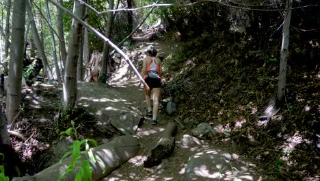 mujer joven caminando por un sendero sombreado