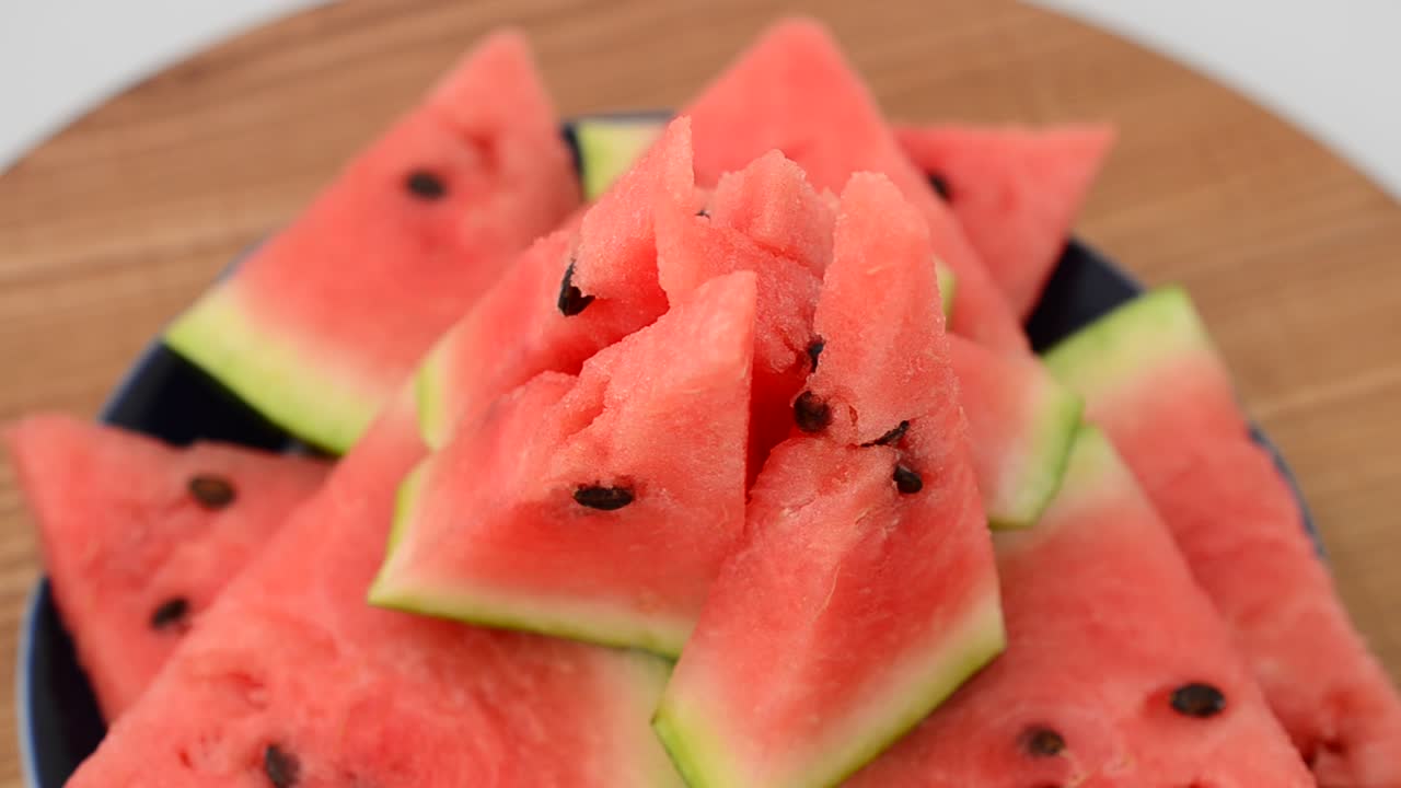 Shooting of a watermelon on a kitchen board. Shooting in the movement