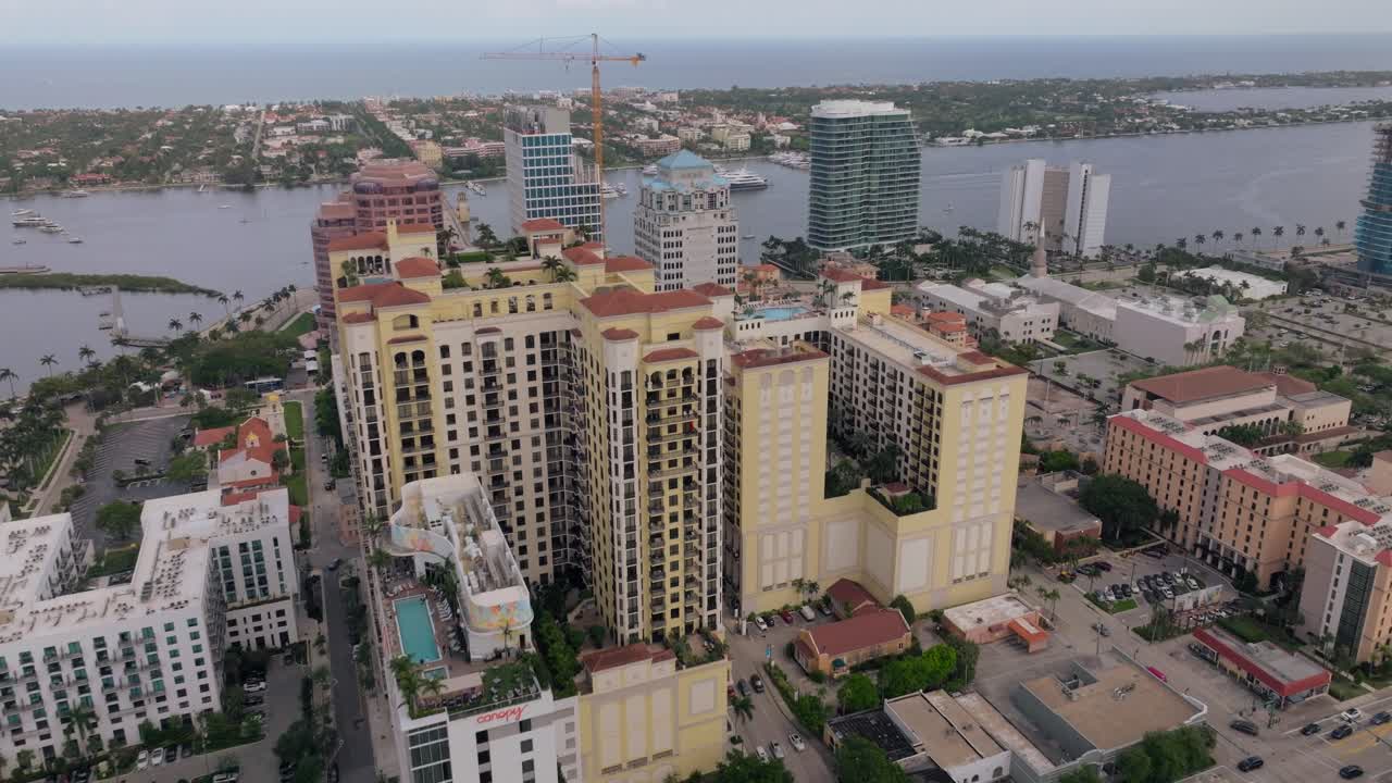 Aerial View of Coastal Cityscape with Buildings, Waterway, and Boats