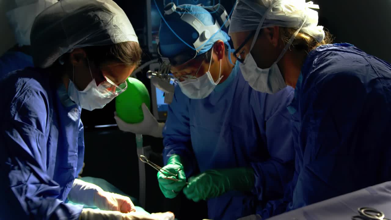 OR team starting post drape, passing tools, treating patient while blue lock overlaying team