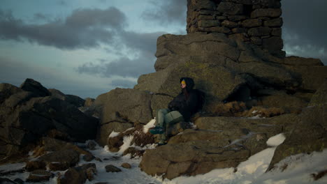 Hand-held-shot-of-a-hiker-resting-at-the-peak-of-the-Lovstakken-enjoying-the-views