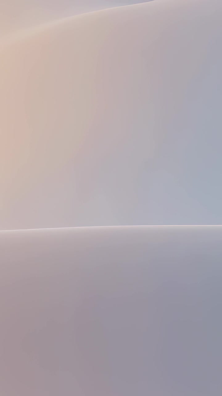 Vertical video: Drifting camera revealing pastel gradient surface close-up, showing lower curve
