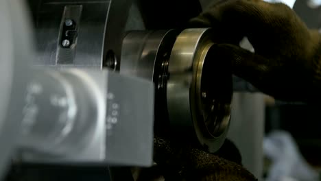 closeup worker hands bind part to compressor in workshop