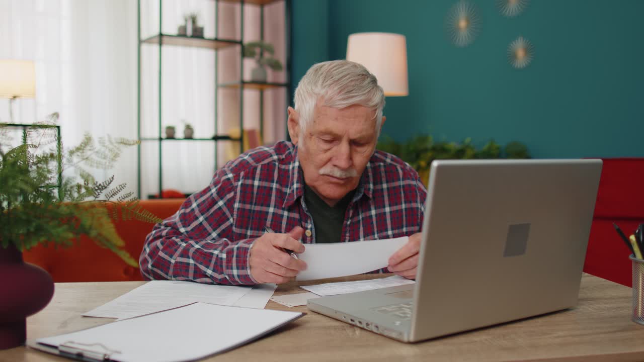 abuelo serio hombre calculando facturas del hogar préstamo bancario en línea pagos de gastos domésticos